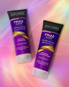 John Frieda Frizz Ease Miraculous Recovery shampoo and conditioner against a pink background
